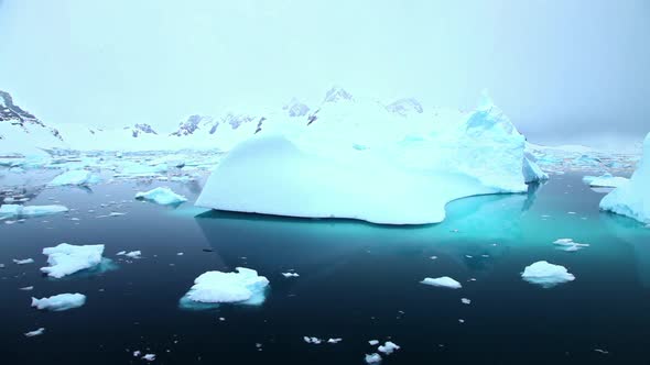 Sailing past icebergs in Antarctica alt