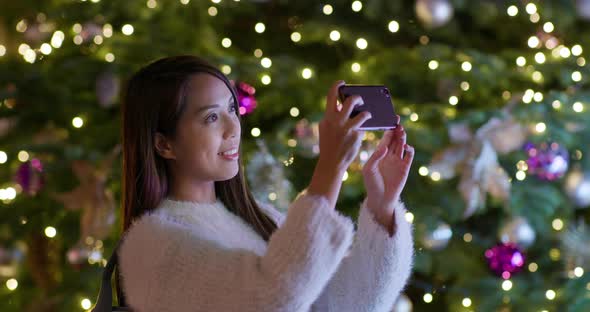 Woman Take Photo on Cellphone in Christmas Time