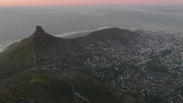 Aerial Panoramic Footage of City on Ocean Coast at Twilight alt