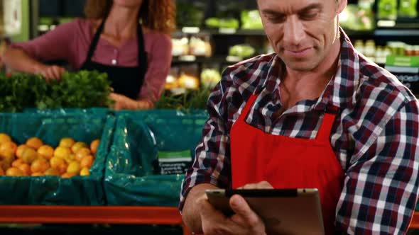 Smiling staff interacting with each other in organic section alt