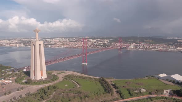 Aerial shot of Christ the King and 25 de Abril Bridge