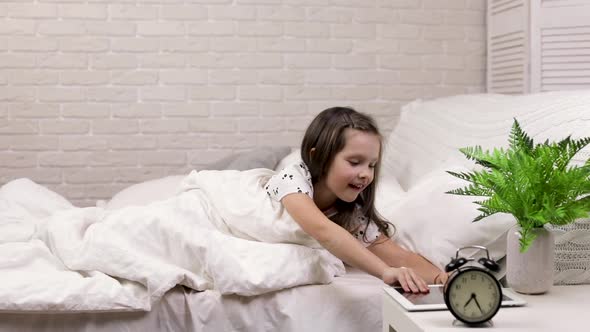 Cute Little Child Girl Wakes Up From Sleep in Bed