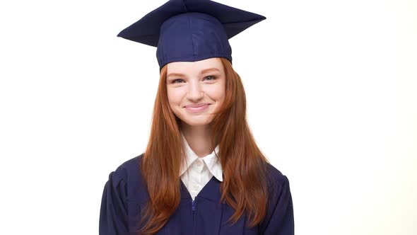 Happy Beautiful Young Foxy Graduate Girl in Blue Robe and Square Academical Cap Laughing Sweetly on alt