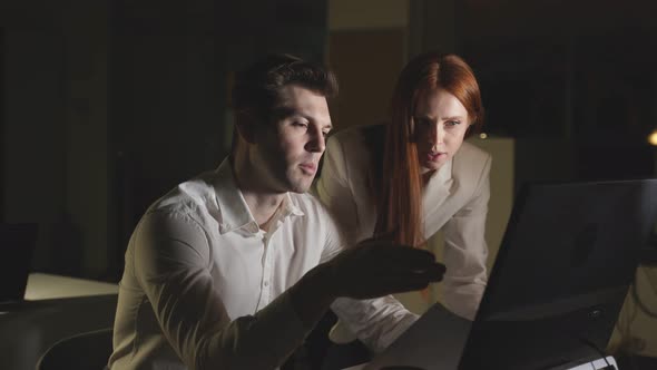 A Man and a Woman in a Night Office Managers Work the Night Shift alt