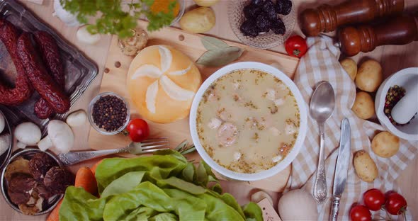 Soup In Bowl Amidst Various Ingredients Assorted On Wooden Table alt