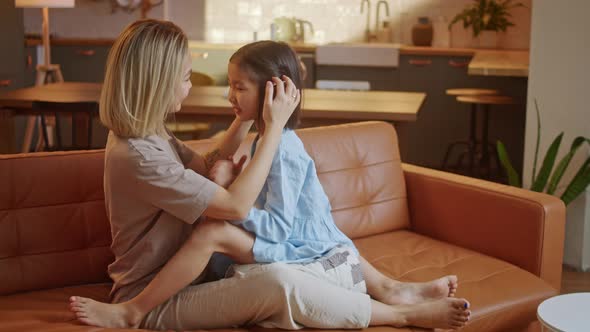 Happy Little Asian Cute Girl Hugging Embracing Her Mom Enjoying Bonding and Laughing Together alt