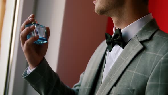 Groom Splits the Perfume on Himself in Wedding Day. Slow Motion. Close Up alt