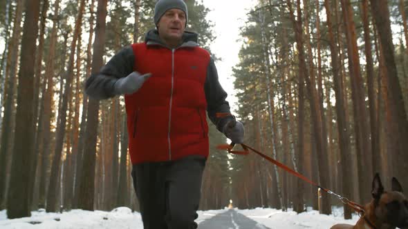 Active Man Jogging with Dog in Winter alt