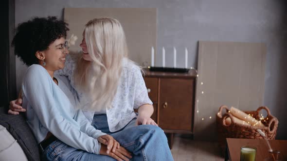 Lesbian Couple Kiss and Smile Playing and Dancing Sitting on the Couch