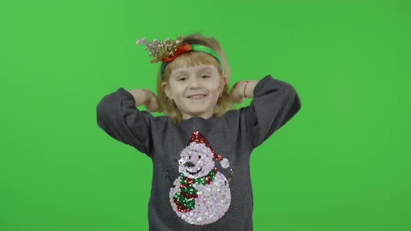 Happy Beautiful Little Girl in a Sweater with a Snowman. Christmas. Chroma Key alt