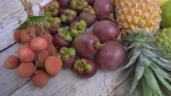 Lots of Tropical Fruits on a Wooden Background alt