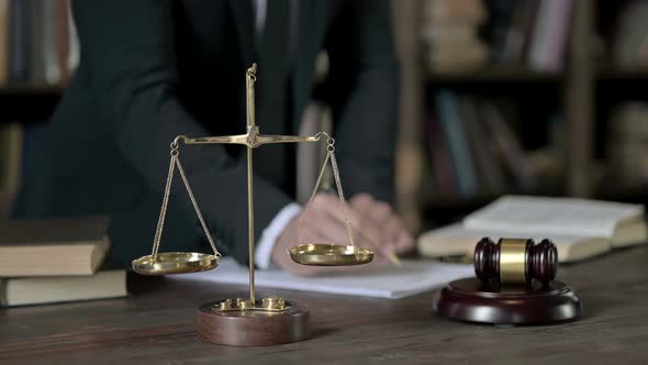 Close Up Shoot of Judge Hand Signing Paper in Court Room Table alt