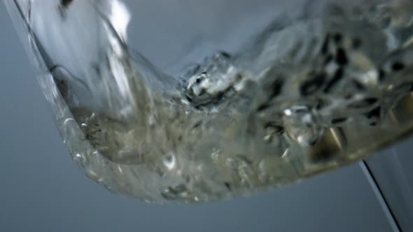 Closeup White Wine Bubbling Splashing in Goblet alt