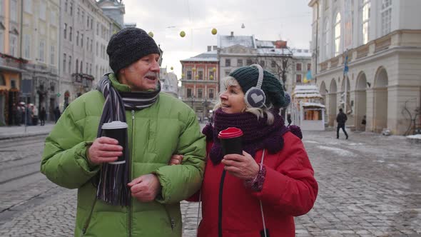 Senior Wife Husband Tourists Drinking From Cups Enjoying Hot Drink Tea on City Central Street alt