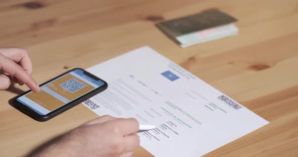 Vaccinated person checking digital health passport app in mobile phone
