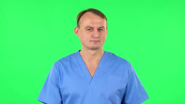 Medical Man Flirts, Blows a Kiss and Winks, Green Screen alt
