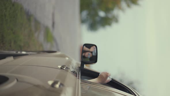 Driver Throwing Away Plastic Bottle and Medical Mask From Car Window on Road. alt