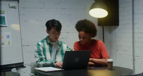 Young Colleagues are Working on a Common Project in a Modern Office alt