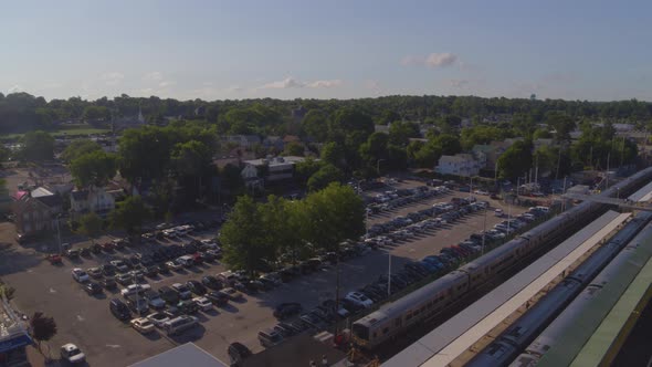 Pedestal Down Shot Trains Stopped at Station Near a Parking Lot in Long Island alt