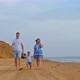 Happy Family Walks Along the Seashore - VideoHive Item for Sale