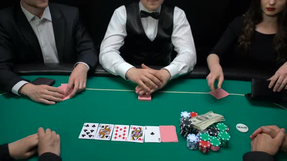 Risky Casino Players Putting Money and House Key on Table, Raising Bet, Strategy alt