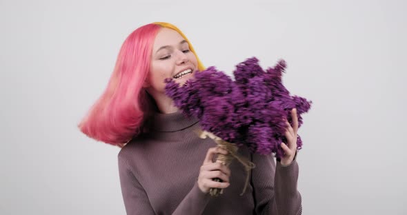 Teenager Girl with Dyed Purple Yellow Hair Holding Lilac Flowers in Hands alt