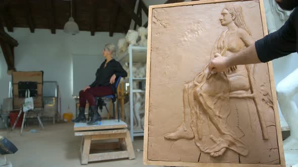 Sculptor is Modeling a Realistic, Figurative Relief with Model