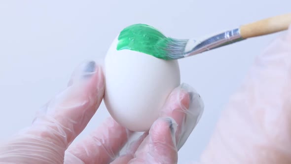 Closeup of a Person Painting Easter Eggs with a Special Brush
