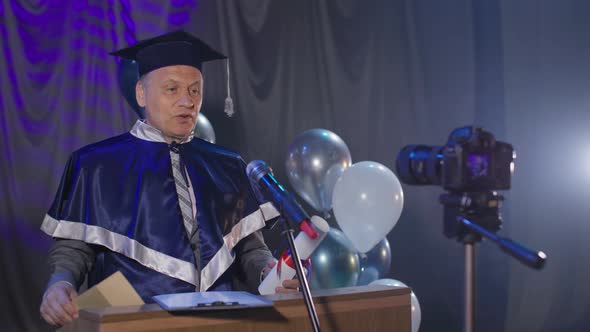 Happy University Teacher Congratulates Graduates on End of Academic Year and Presents Them with alt