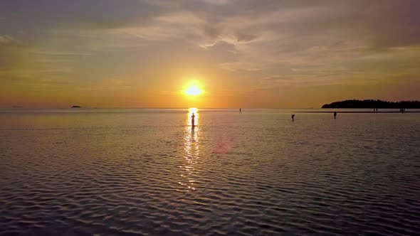 Young Woman Silhouette Walking Alone In the Sea at Beautiful Sunset Thailand alt