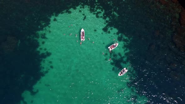 Aerial Photography of Tourist Boats in the Beautiful Clear Turquoise Sea and People Swimming Next to alt