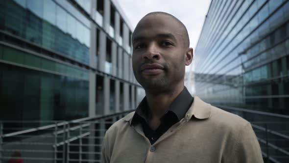 Serious Young Professional Standing Outdoors alt