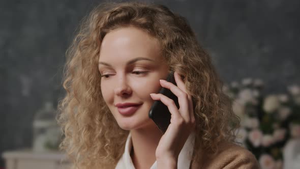 Close Up of a Young Caucasian Woman Shy Talking on a Phone alt