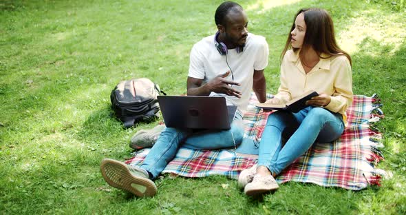 Multiracial Friends Studying in Park