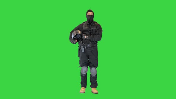 Riot Policeman Standing Holding His Helmet in Hands on a Green Screen Chroma Key alt