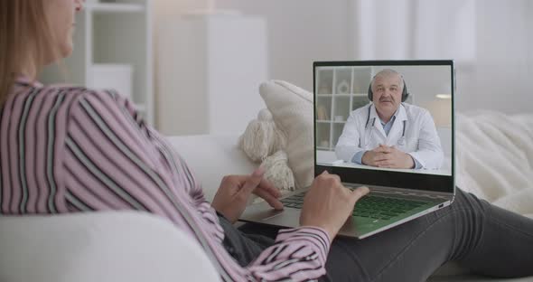 Male Doctor and Female Patient Are Communicating Online, Woman Staying Home and Physician Is Working alt