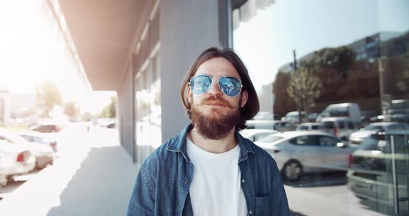 Bearded Male Walking Near Building