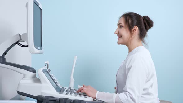 Cheerful Doctor Does Ultrasonography to Patient in Hospital alt