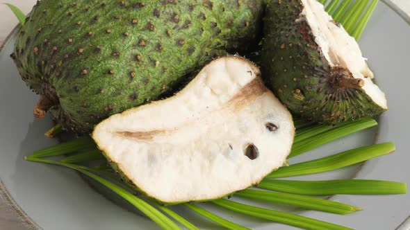 Closeup of Green Soursop Graviola, Exotic, Tropical Fruit Guanabana on Plate alt