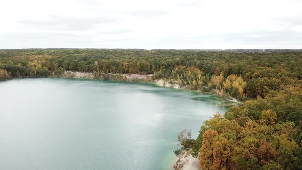 Forest lake landscape. Aerial view with drone of green forest and lake alt