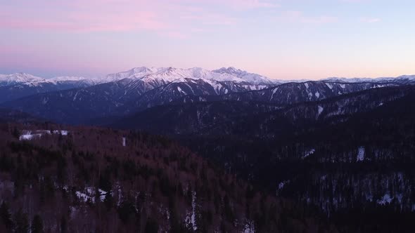 View of the beautiful snow-capped mountains on a winter day. Drone camera.