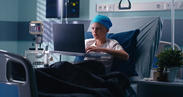 Little Patient Using Laptop in Hospital Ward alt
