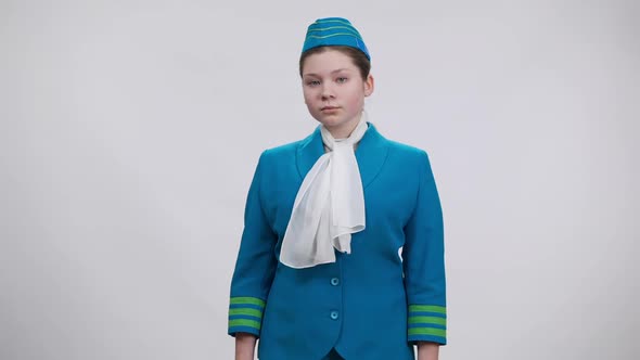 Confident Future Stewardess Saluting and Smiling Looking at Camera alt