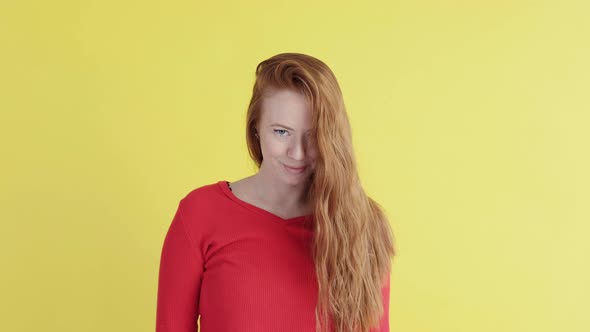 Portrait of a red-haired woman on a yellow background