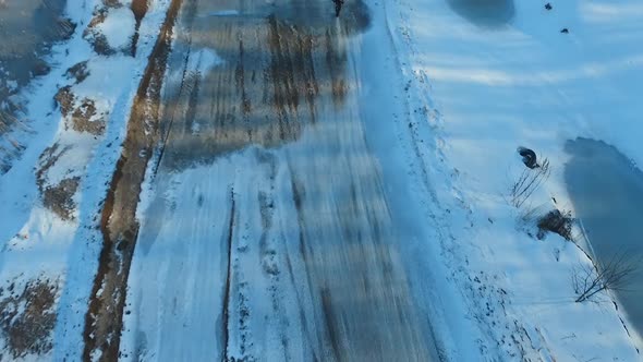 a motorcyclist performs stunts on a winter track