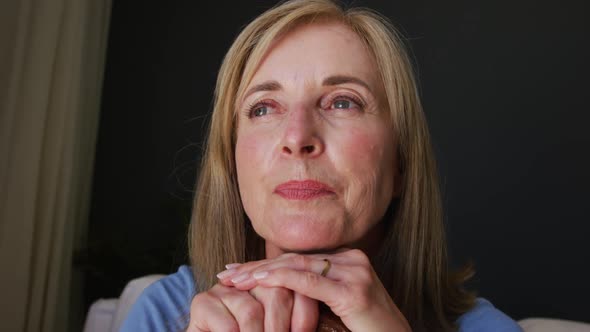 Close up of caucasian senior woman holding a walking stick at home alt