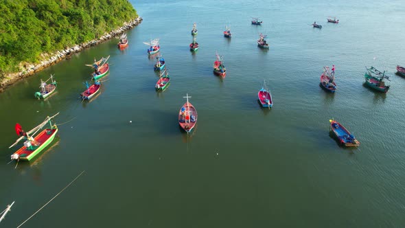 Many fishing boats on the coast beside the mountains, beautiful sea area in Thailand. alt