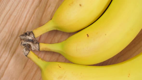Bananas Laying On Maple Wood Cutting Board Spinning 01