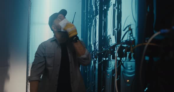 Man with Radio Checking Service Box Behind Stage alt