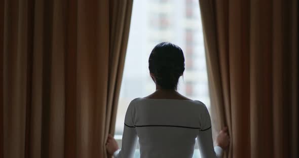 Woman open the curtain alt